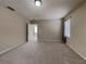 Large carpeted main bedroom with a doorway to en suite bathroom and two windows at 7806 Tanbier Dr, Orlando, FL 32818