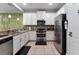 Well-equipped kitchen featuring stainless steel appliances, granite countertops, and ample cabinetry at 8122 Roseville Rd, Davenport, FL 33896