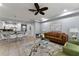 Open-concept living room featuring a comfortable sofa, modern furnishings, and neutral decor at 8122 Roseville Rd, Davenport, FL 33896