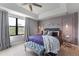 Main bedroom showcasing modern wall decor, a plush bed, and a cozy sitting bench at 8122 Roseville Rd, Davenport, FL 33896