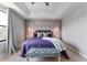 Main bedroom showcasing modern wall decor, a plush bed, and a cozy sitting bench at 8122 Roseville Rd, Davenport, FL 33896