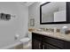 Bathroom with modern vanity with granite countertops, and a decorative mirror at 8124 Roseville Rd, Davenport, FL 33896