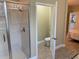 Modern bathroom featuring a glass-enclosed shower and an adjoining toilet area, providing convenience and privacy at 8124 Roseville Rd, Davenport, FL 33896