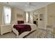 Elegant bedroom with neutral tones, stylish furniture, a plush rug, and a view into the connected bathroom at 8124 Roseville Rd, Davenport, FL 33896