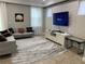 Cozy living room featuring a modern sofa, stylish rug, and mounted TV for a perfect entertainment space at 8124 Roseville Rd, Davenport, FL 33896