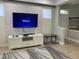 Modern living room with a wall-mounted TV, stylish accent wall, and a comfortable entertainment space at 8124 Roseville Rd, Davenport, FL 33896