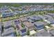 Neighborhood aerial view shows houses, streets, and sidewalks; many homes have solar panels at 8226 Nemours Pkwy, Orlando, FL 32827