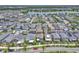 A vast aerial view of houses in a well-maintained community near a lake, emphasizing the location's appeal at 8226 Nemours Pkwy, Orlando, FL 32827