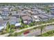 A beautiful aerial view of a neighborhood with houses and a lake in the background, showcasing community living at 8226 Nemours Pkwy, Orlando, FL 32827