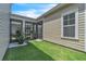 A green backyard is showcased, with a lovely screen enclosed lanai and a well-manicured lawn at 8226 Nemours Pkwy, Orlando, FL 32827