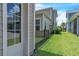 A well manicured back lawn area is shown with a black metal fence and attractive vegetation at 8226 Nemours Pkwy, Orlando, FL 32827