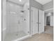 This bathroom features a sleek, glass-enclosed shower with modern fixtures and tile work at 8226 Nemours Pkwy, Orlando, FL 32827