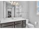 Bathroom with vanity, mirror, and shower with glass door at 8226 Nemours Pkwy, Orlando, FL 32827