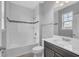 Bathroom boasts shower-tub combo, tiled walls, vanity, and ample natural light at 8226 Nemours Pkwy, Orlando, FL 32827
