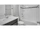Bathroom featuring a shower-tub combo and vanity with dark cabinets at 8226 Nemours Pkwy, Orlando, FL 32827