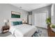 A staged bedroom features a large bed, decorative art and a closet at 8226 Nemours Pkwy, Orlando, FL 32827