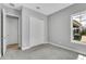 Neutral bedroom with carpeting, closet, and a view of the backyard patio at 8226 Nemours Pkwy, Orlando, FL 32827