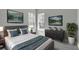 Comfortable bedroom featuring a king-sized bed, wall-mounted TVs, and bright windows at 8226 Nemours Pkwy, Orlando, FL 32827
