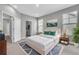 Bedroom with a queen bed, natural lighting, art on the wall, and a rug on the floor at 8226 Nemours Pkwy, Orlando, FL 32827