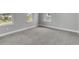 Cozy bedroom featuring carpeted floors, base trim and an abundance of natural light at 8226 Nemours Pkwy, Orlando, FL 32827