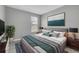 A staged bedroom has a plush bed, decorative art and a large window at 8226 Nemours Pkwy, Orlando, FL 32827