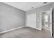 Cozy bedroom featuring carpeted floors, ensuite bath, and a closet at 8226 Nemours Pkwy, Orlando, FL 32827
