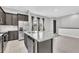 Kitchen featuring stainless steel appliances, dark cabinets, and granite countertops with an eat-in island at 8226 Nemours Pkwy, Orlando, FL 32827