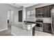 The kitchen island offers granite counter tops and stainless steel appliances and fixtures at 8226 Nemours Pkwy, Orlando, FL 32827