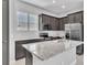 Granite counter tops highlight this sleek kitchen with stainless steel appliances and subway tile backsplash at 8226 Nemours Pkwy, Orlando, FL 32827