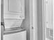 An interior view of a laundry area featuring a white stacked washer and dryer unit at 8226 Nemours Pkwy, Orlando, FL 32827