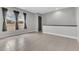 Upstairs living room area with gray paint, neutral tile, and well-lit windows at 8226 Nemours Pkwy, Orlando, FL 32827