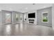 Open living room featuring a sleek fireplace, recessed lighting, and neutral tones throughout at 8226 Nemours Pkwy, Orlando, FL 32827
