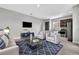 Open-concept living room with neutral tones, modern furniture, and access to the kitchen at 8226 Nemours Pkwy, Orlando, FL 32827