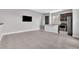 Open-concept living room and kitchen area with sleek gray tile floors and modern fixtures at 8226 Nemours Pkwy, Orlando, FL 32827