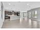 Open concept living space with a kitchen island, tile flooring, and lots of natural light at 8226 Nemours Pkwy, Orlando, FL 32827