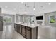 Spacious, open-concept living area featuring a kitchen island, fireplace, and tile flooring at 8226 Nemours Pkwy, Orlando, FL 32827