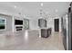 Spacious open-concept living area with a modern fireplace and stainless steel kitchen appliances at 8226 Nemours Pkwy, Orlando, FL 32827