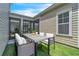 Inviting outdoor patio with modern table and seating, perfect for relaxing and entertaining on the lawn at 8226 Nemours Pkwy, Orlando, FL 32827