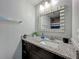 Bathroom featuring granite countertop, contemporary mirror, and updated fixtures at 8606 Port Said St, Orlando, FL 32817