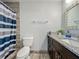 Modern bathroom with granite countertop, updated vanity, and shower with stylish curtain at 8606 Port Said St, Orlando, FL 32817