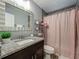 Stylish bathroom featuring granite countertops and a shower with pink curtain at 8606 Port Said St, Orlando, FL 32817