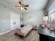 Cozy bedroom with wood-look tile flooring and a classic ceiling fan at 8606 Port Said St, Orlando, FL 32817
