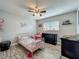 Adorable bedroom featuring a charming pink metal bed frame and wood-look tile flooring at 8606 Port Said St, Orlando, FL 32817