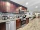Beautiful kitchen featuring stainless steel appliances, dark cabinets, and granite countertops at 8606 Port Said St, Orlando, FL 32817