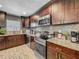Kitchen features stainless steel appliances, granite countertops, and dark cabinets at 8606 Port Said St, Orlando, FL 32817