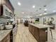 Open-concept kitchen with island, stainless steel appliances, and dark cabinets at 8606 Port Said St, Orlando, FL 32817
