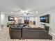 Open living room featuring wood-look floors, comfortable seating, and a view of the entry and other spaces at 8606 Port Said St, Orlando, FL 32817