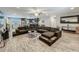 Expansive living room boasts wood-look floors, a large sectional, and a seamless transition into the kitchen area at 8606 Port Said St, Orlando, FL 32817