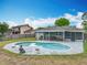A refreshing backyard pool is surrounded by a patio and lovely landscaping at 8606 Port Said St, Orlando, FL 32817