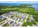 An aerial view presents a vibrant lakeside community with lush greenery at 1123 Dora Parc Ln, Mount Dora, FL 32757